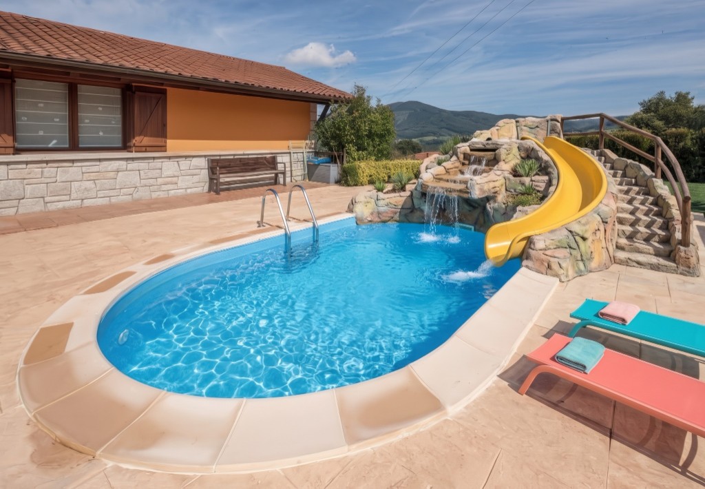 The same oval pool with a rock grotto, cascade, yellow slide and loungers, generated with Mix&Design