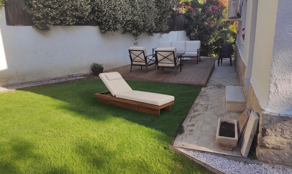 The same patio with a wood and beige-canvas sun lounger on the lawn, generated with Mix&Design try your furniture